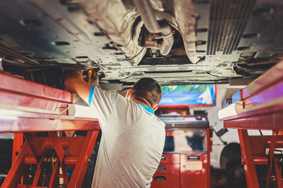 mechanic inspecting used car